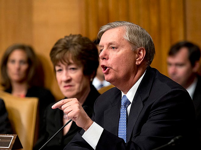 Sen. Lindsey Graham, R-S.C., right, joined by Sen. Susan Collins, R-Maine, left, addresses Attorney General Eric Holder as he testifies at a Senate Appropriations subcommittee as lawmakers examine the budget for the Justice Department, on Capitol Hill in Washington, Thursday, June 6, 2013. Some senators had expressed concern about the news of a long-running National Security Agency program to collect phone record of millions of U.S. customers of Verizon as part of an anti-terrorist effort. Graham defended the program and said he would not be concerned if records of calls to his phone number had been part of the NSA sweep. (AP Photo/J. Scott Applewhite)