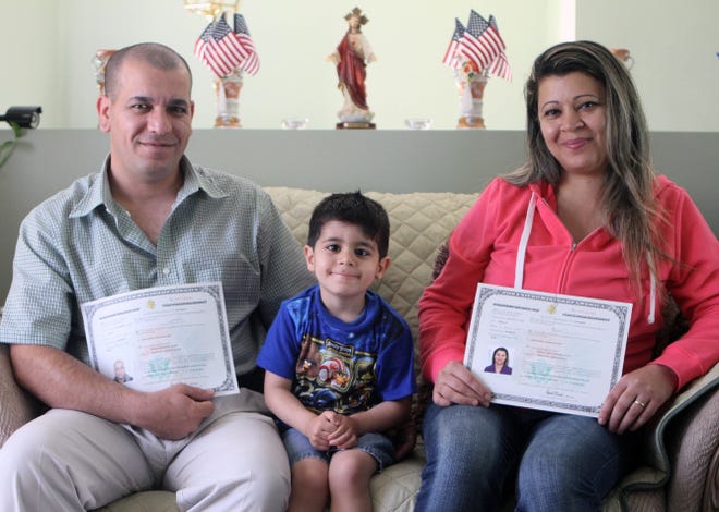 Atheer Jajou and his wife, Baydaa, the first Iraqi refugees resettled in Rhode Island, became citizens on Monday. Their son, Alex, 4, is with them.
