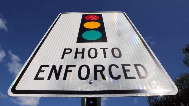 A sign in Royal Palm Beach warns of a red light camera. (Palm Beach Post file photo)