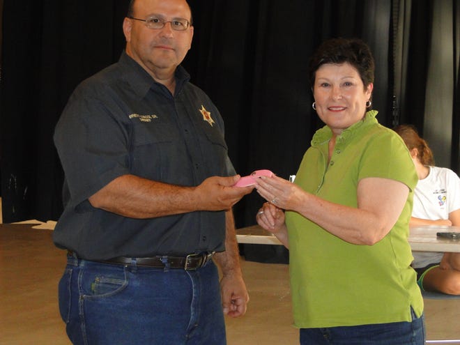 Iberville Parish Sheriff Brett Stassi presents a Mace keychain to Peggy Allain at a Women's Self-Defense Class at the Carl. F. Grant Center recently.