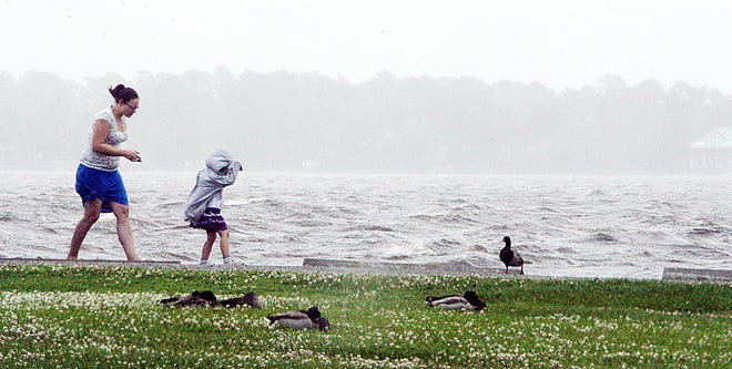 Four-year-old Sylvia Gartin and her mom, Megan Gartin, feel the wind from the first bands of Tropical Storm Andrea at Union Point Park on Friday before heavy rainfall started.