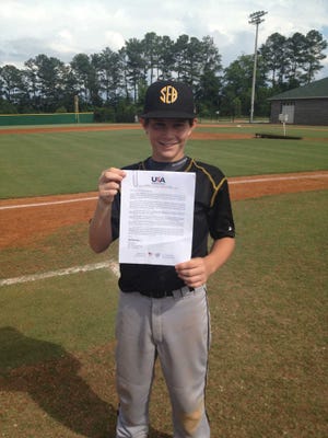 Submitted photoHudson Sapp holds up paperwork showing he has been selected as one of 40 candidates for the 12-and-under national team. If selected, Sapp will compete in Chinese Taipei next month.