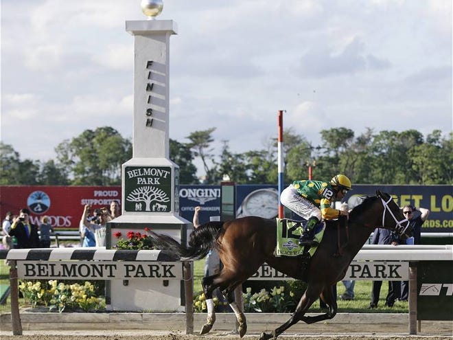Palace Malice, ridden by jockey Mike Smith, crosses the finish line to win the the 145th Belmont Stakes horse race at Belmont Park in Elmont, N.Y., on Saturday, June 8, 2013.