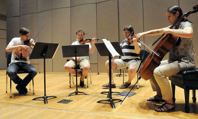 The Atrium String Quartet - from left, Alexey Naumenko and Anton Ilyunin, violins; Dmitry Pitulko, viola; and Anna Gorelova, cello - rehearse Sergei Prokofiev's Quartet in B minor, Op. 50, one of three pieces they will perform at 7:30 p.m. Sunday in White Concert Hall as part of the 27th Sunflower Music Festival.