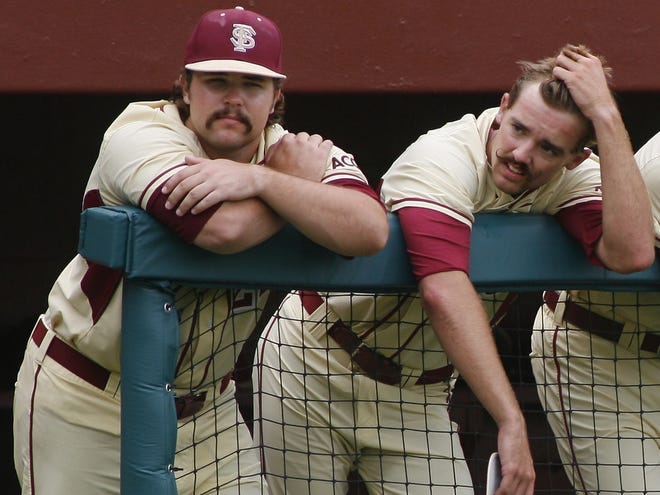 Florida State starting pitcher Scott Sitz, left, and Gage Smith react in the dugout in the ninth inning Sunday against Indiana in Tallahassee. Indiana advanced to the College World Series.