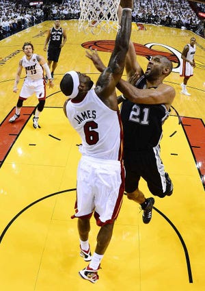 Larry W. Smith Associated Press The Heat's LeBron James blocks the shot of Spurs forward Tim Duncan during Game 2 of the NBA Finals on Sunday night in Miami.