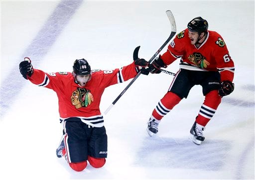 Chicago Blackhawks right wing Patrick Kane (88) celebrates his goal with center Andrew Shaw (65) during the second overtime period in Game 5 of the NHL hockey Stanley Cup playoffs Western Conference finals against the Los Angeles Kings, Saturday, June 8, 2013, in Chicago. The Blackhawks won 4-3 and advanced to the Stanley Cup finals. (AP Photo/Charles Rex Arbogast)