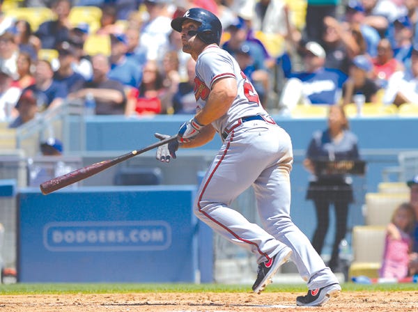 Atlanta's Dan Uggla hits a three-run homer against the L.A. Dodgers on Sunday. (Mark J. Terrill | Associated Press)