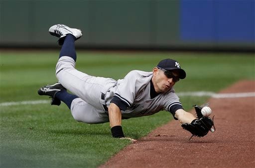 Yankees right fielder Ichiro Suzuki bobbles a foul ball hit by Mariners' Raul Ibanez in the seventh inning Sunday, June 9, 2013, in Seattle. Suzuki failed to make the catch and was charged with dropped foul pop error on the play.