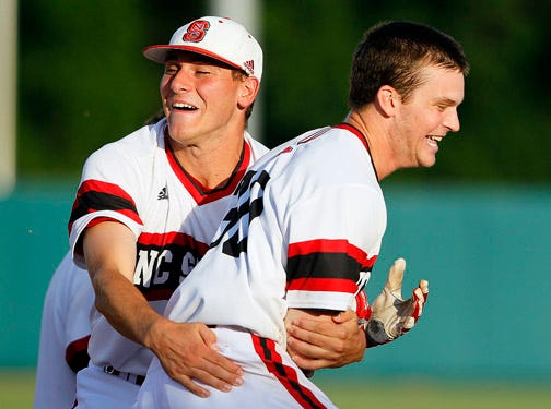 North Carolina State's Jake Fincher, right, is congratulated by teammate D.J. Thomas after Fincher drove in the game-winning run against Rice for a 4-3 victory in an NCAA Tournament super regional game.