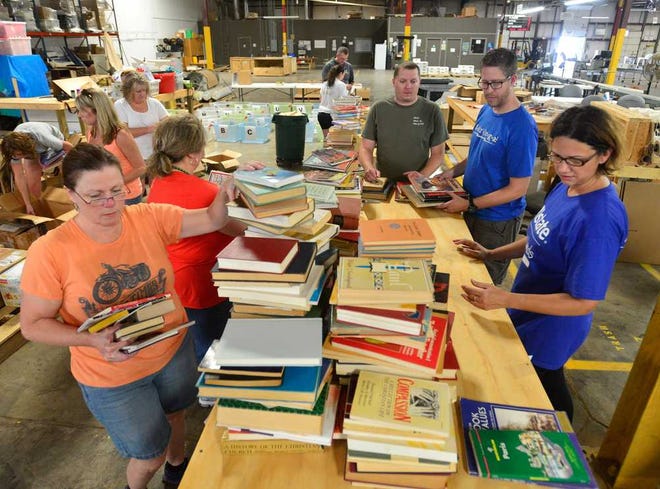 Volunteers help organize a recent shipment of book for the Books For Keeps organization on Sunday, June 9, 2013, in Athens, Ga.  (Richard Hamm/Staff) OnlineAthens / Athens Banner-Herald