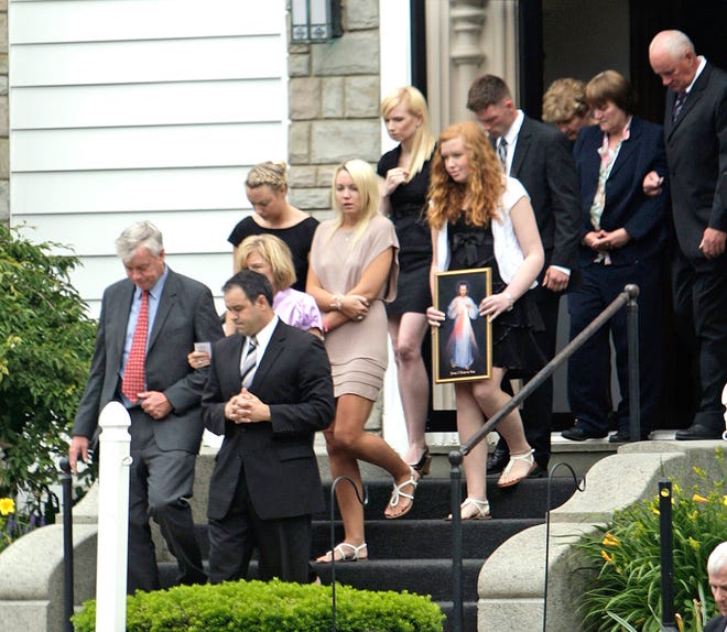 The family of Joey Glynn leaves St. Bridget Catholic Church in Abington after his funeral on Monday. Joey, a former Cardinal Spellman High School basketball star, collapsed on Monday during a pickup game in Watertown.