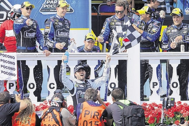 Jimmie Johnson, center, celebrates in victory lane after winning the Pocono 400 on Sunday in Long Pond, Pa. Johnson led 128 of 160 laps in a convincing win.