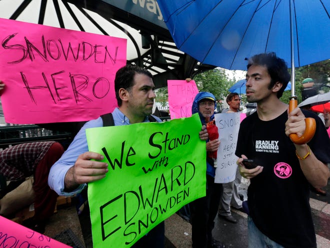 Demonstrators hold signs supporting Edward Snowden in New York's Union Square Park on Monday. Snowden, who says he worked as a contractor at the National Security Agency and the CIA, gave classified documents to reporters, making public two sweeping U.S. surveillance programs and touching off a national debate on privacy versus security.