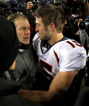 FILE- In this Jan. 14, 2012, file photo, then-Denver Broncos quarterback Tim Tebow, right, hugs New England Patriots head coach Bill Belichick following an NFL divisional playoff football game in Foxborough, Mass. Tebow is joining the New England Patriots, according to a report by ESPN on Monday, June 10, 2013. The high-profile quarterback who spent one season mostly on the sidelines with the New York Jets is expected to attend the start of the Patriots three-day minicamp on Tuesday. (AP Photo/Charles Krupa, File)