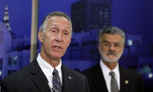 Cleveland Police Chief Michael McGrath, left, answers questions during a news conference Tuesday in Cleveland. McGrath said one supervisor was fired, two were demoted and nine were suspended for their roles in a November chase in which officers fired 137 shots and killed a fleeing driver and his passenger. Cleveland Mayor Frank Jackson, right, listens.