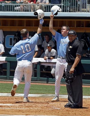 North Carolina's Brian Holberton (10) is congratulated by Michael Russell at home plate after hitting a two-run home run against South Carolina during the second inning of an NCAA college baseball tournament super regional game in Chapel Hill, N.C., Tuesday, June 11, 2013. (AP Photo/Gerry Broome)