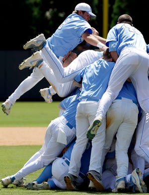 North Carolina celebrates as Chaz Frank, top, jumps on the dogpile after the team's 5-4 victory against South Carolina in the super regional round of the NCAA Tournament.