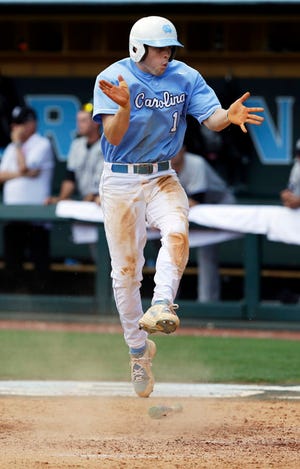 North Carolina's Landon Lassiter celebrates after scoring on a triple by Colin Moran in the sixth inning of the Tar Heels' 5-4 victory against South Carolina in the NCAA Tournament super regional on Tuesday.