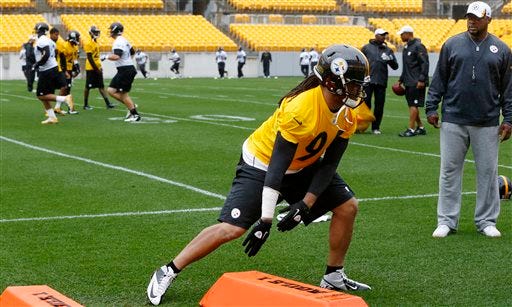 Pittsburgh Steelers head coach Mike Tomlin, right, watches as linebacker Jarvis Jones (95) does agility drills during the NFL football practice on Thursday, June 6, 2013 in Pittsburgh.