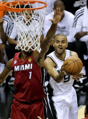 Spurs' Tony Parker shoots against the Chris Bosh. Parker was injured early in the second half on Tuesday.