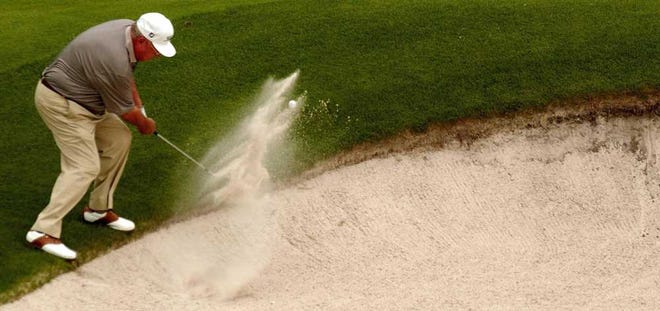 The Times-Union Miller Barber hits out of the bunker on No. 18 while playing in the 2002 Legends of Golf event at the King & Bear in St. Augustine.
