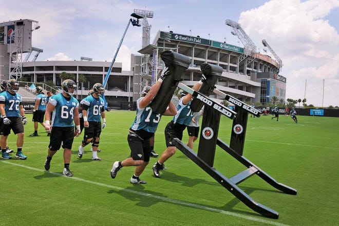 Bob.Self@jacksonville.com Offensive linemen push the sled during drills at Wednesday's minicamp session. Top pick Luke Joeckel will join Eugene Monroe as the team's starting tackles this season.