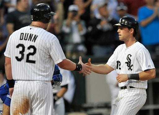 Chicago White Sox's Gordon Beckham (12), celebrates with teammate Adam Dunn (32), after hitting a three-run home during the fourth inning of a baseball game against the Toronto Blue Jays in Chicago, Tuesday, June 11, 2013. (AP Photo/Paul Beaty)
