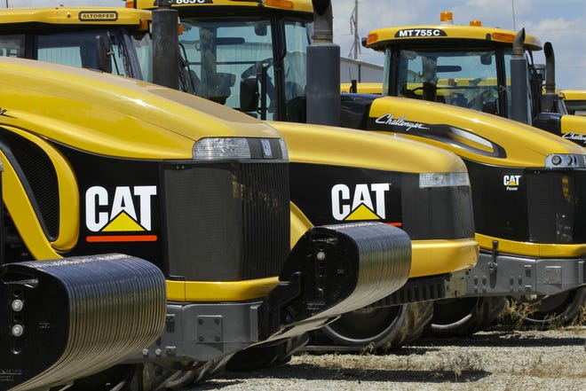 In this Wednesday, June 20, 2012, file photo, shows Caterpillar logos on earth moving tractors and equipment in Clinton, Ill. (AP Photo/Seth Perlman)