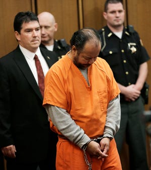 Ariel Castro walks into the courtroom during his arraignment Wednesday, June 12, 2013, in Cleveland. Castro, 52, is accused of holding three women captive in his Cleveland home for about a decade pleaded not guilty to hundreds of charges, including rape and kidnapping. (AP Photo/Tony Dejak)