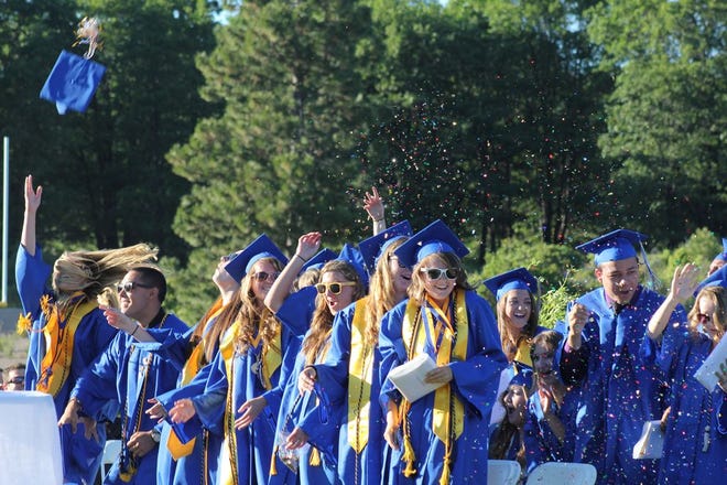 New Mount Shasta High School graduates toss their caps into the air in celebration at the conclusion of their commencement ceremony Friday evening. More photos can be found at facebook.com/mtshastanews  Photo by Skye Kinkade