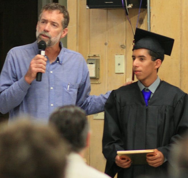 Jefferson High School teacher Tim Loughlin praises graduate Michael Harris-Lopez during last week’s commencement 
ceremony at Mt. Shasta City Park. Principal Ed Stokes said he likes how 
Jefferson graduations are personalized for each graduate. See more photos at Facebook.com/mtshastanews  Photo by 
Steve Gerace