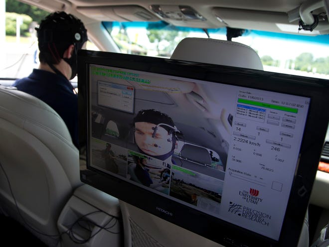Russ Martin of American Automobile Association is seen on a monitor in a research vehicle skull cap to the research vehicle during a demonstrations in support of their new study on distracted driving in Landover, Md., on Tuesday.