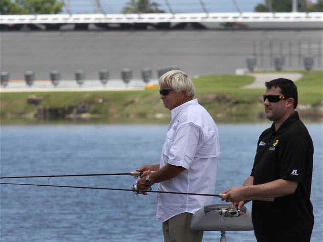 Professional angler and TV personality Jimmy Houston, left, and NASCAR driver Tony Stewart fish Lake Lloyd at Daytona International Speedway on Wednesday, June 12, 2013, during a promotional event for the July 6 Coke Zero 400 race.