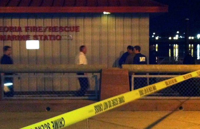 Authorities set up a crime scene at the Peoria Fire/Rescue Marine Station on the Peoria Riverfront after a body was reportedly found Tuesday night floating in the Illinois River.