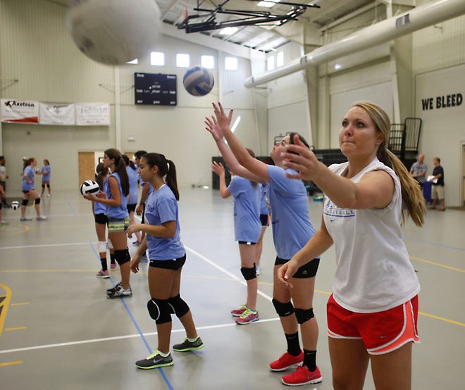North Carolina defensive specialist/libero Chaney LaReau, front, helps instruct a volleyball camp at The Epiphany School on Thursday. The camp, which had 35 registered, was also instructed by UNC assistant Tyler Adams and new Harvard assistant Arturo Rivera. It will continue with its second day on Friday.