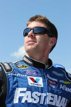 Driver Carl Edwards watches after qualifying for Sunday's NASCAR Sprint Cup series auto race at Michigan International Speedway Friday, June 14, 2013, in Brooklyn, Mich. Edwards won the pole with a speed of 202.452 m.p.h. (AP Photo/Bob Brodbeck)
