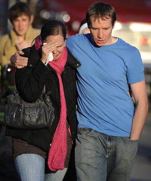 Alissa Parker grieves with her husband, Robbie, as they leave the firehouse staging area after receiving word that their daughter was one of the 20 children killed in the Sandy Hook School shooting on Dec. 14, 2012, in Newtown, Conn. Newtown has marked the passage of six months since the massacre at Sandy Hook Elementary School with a moment of silence.