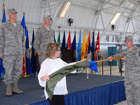 Col. Daniel Runyon (from left), the 96th Maintenance Group commander and Maj. Aaron Whitlock, the former 96th Maintenance Operations Squadron commander watch personnel furl the squadron’s guidon during an inactivation ceremony here June 6. Debra Ray, administrative assistant, sleeved her former unit’s colors with Senior Master Sgt. Jerryl Schultz, the former squadron superintendent. Members who reported to the 96th MOS now reside in maintenance operations, on the 96th MXG staff.