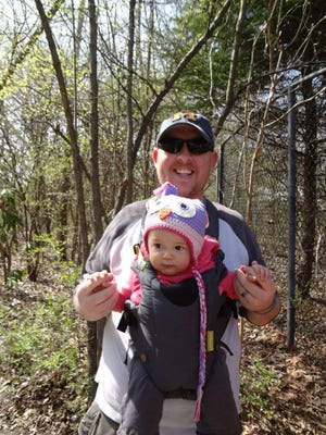This April 2013 photo provided by Jeremy Foster of Kansas City, Mo., shows Foster, 37, with his daughter Sophia, who turns 1 on June 12, at the Kansas City Zoo. Foster is an example of a new generation of fathers who don?t just change the occasional diaper but who, as he puts it, have ?made a conscious decision to share in all the responsibilities in a way that?s equal? with their wives when it comes to childrearing. (AP Photo/Jeremy Foster)