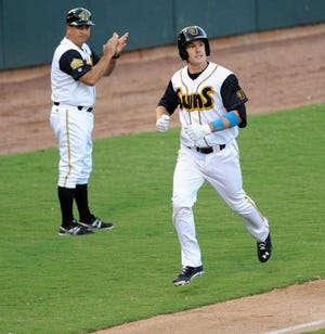 Bob.Mack@jacksonville.com The Suns' Mark Canha rounds the bases after hitting a solo home run in the fifth inning as third base coach Rich Arena celebrates against the Biscuits at the Baseball Grounds of Jacksonville. The game was not over at press time.