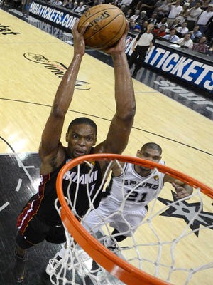Miami Heat's Chris Bosh dunks against the San Antonio Spurs Thursday during the first half of Game 4 of the NBA Finals.