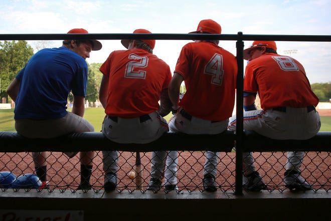 Four Post 82 junior team members talk amongst each other prior to their game against Mint Hill on Wednesday night.