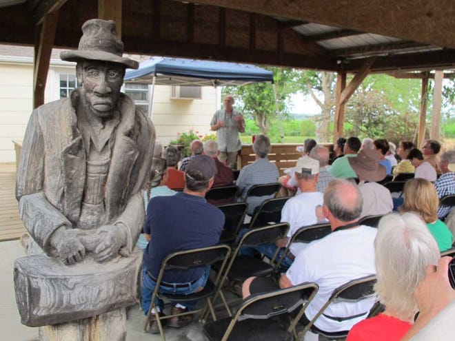 A carved wooden statue welcomes visitors to a session at last year's open house at the Mitchell Farmstead and Mount Mitchell Heritage Prairie near Wamego. This year's open house will be from 9 a.m. to 2 p.m. next Saturday.