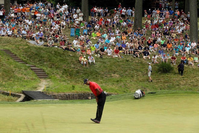 Tiger Woods reacts to a putt on the ninth green during the fourth round of the U.S. Open golf tournament at Merion Golf Club, Sunday in Ardmore, Pa. Woods' last win in a major came in 2008.