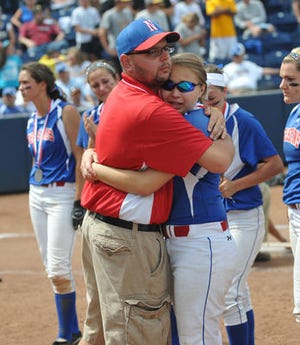 Dave Chichilitti hugs Sarah Snider-Leonhauser following the defeat at the PIAA Class AAAA state championship softball game Friday at Penn State. Neshaminy lost to Canon-McMillan, 4-3. (Photo Bryan Woolston)