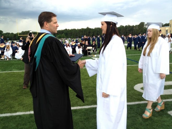 Shawnee High School Principal Matthew Campbell congratulates graduate Katie Kernan of Medford.