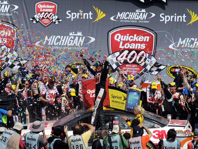 Sprint Cup Series driver Greg Biffle celebrates in Victory Lane after winning the Quicken Loans at Michigan International Speedway on Sunday.