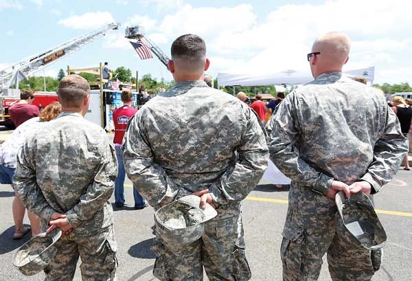 Photo by Tracy Klimek/New Jersey Herald - U.S. Army soldiers stand at attention as Mike Lawlor Banned plays the Star-Spangled Banner honoring veterans during Lowe’s annual county-wide Community Day at the Hampton store on Route 206.