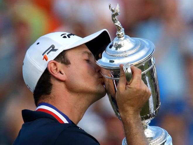 Justin Rose, of England, celebrates with the trophy after winning the U.S. Open golf tournament at Merion Golf Club, Sunday, June 16, 2013, in Ardmore, Pa. (AP Photo/Gene J. Puskar)